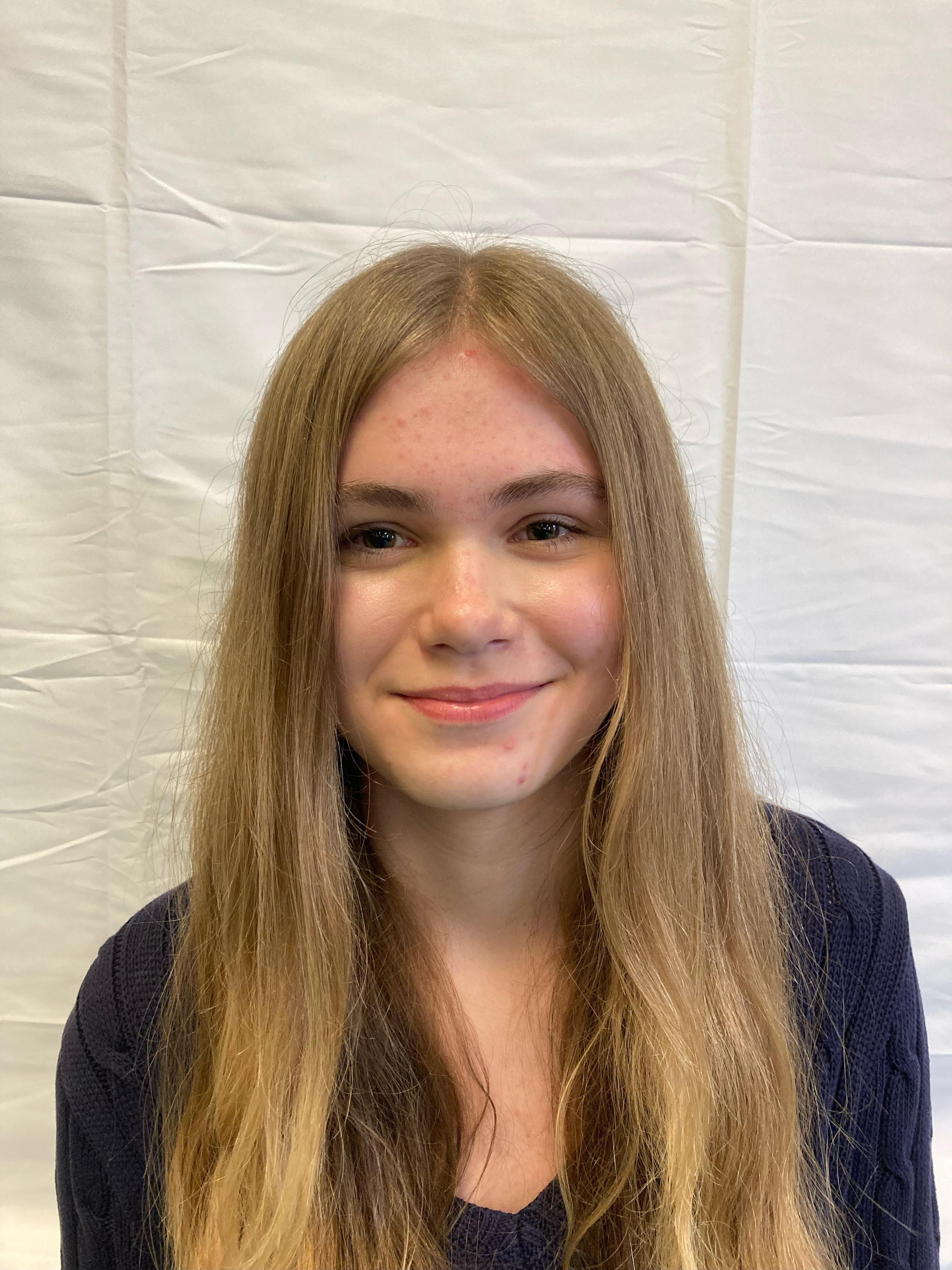 A girl with blonde hair poses for a profile picture.