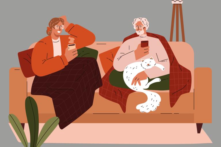 two people sitting on a couch talking