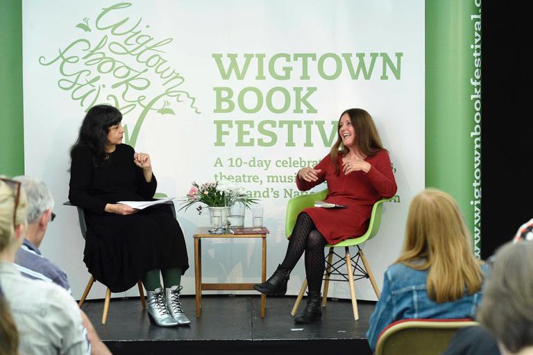 Two people chat as part of a live conversation during Wigtown Book Festival in 2022.