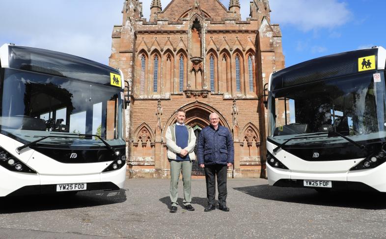 Councillors in front of Crichton Memorial Church building with buses 