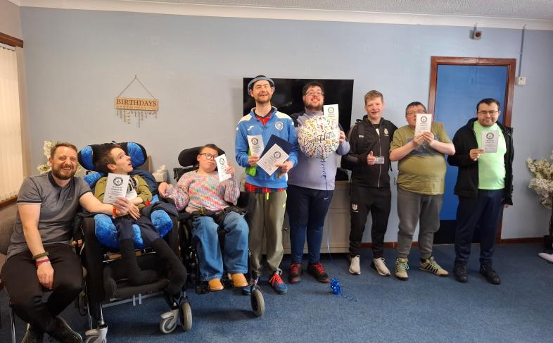 Service users at Stranraer ARC pose with their certificates of recognition. 