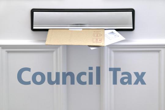 Letters in a letter box, text reads council tax