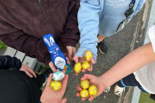 Young people holding Easter chocolates