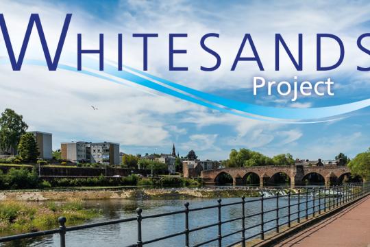 A picture of a river, a bridge and a walkaway along the river in Whitesands.