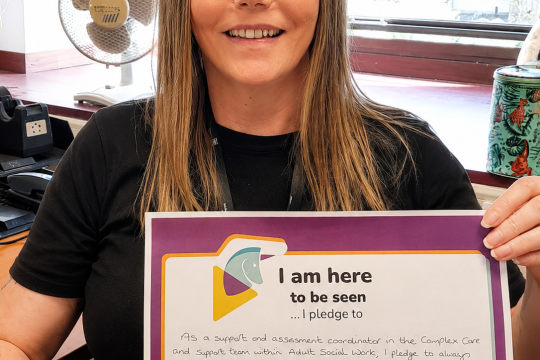 Lorna holds up her Scottish Learning Disability Week pledge