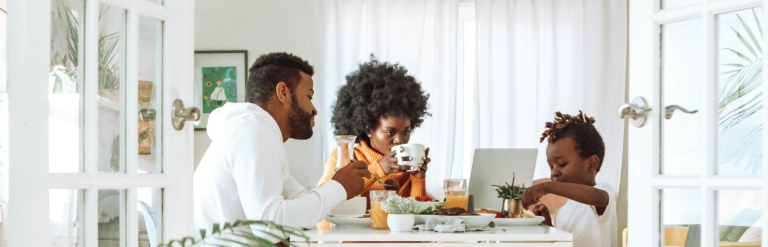 Family eating breakfast in their kitchen.